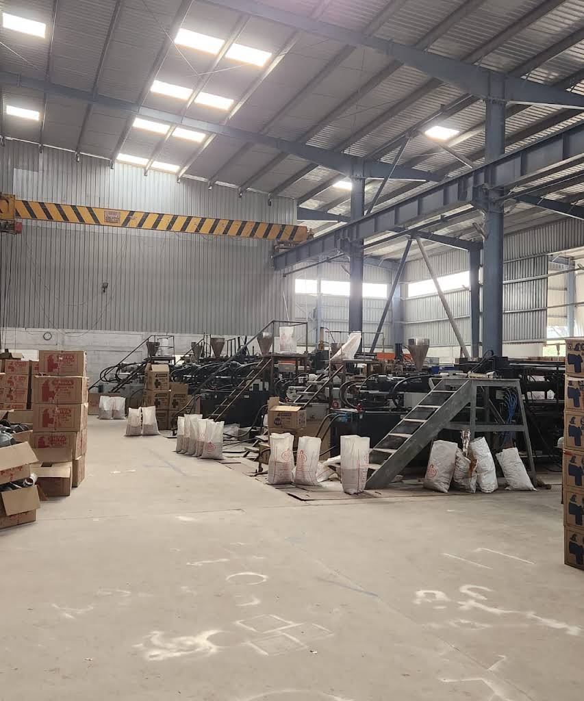 Manufacturing plant interior with overhead crane