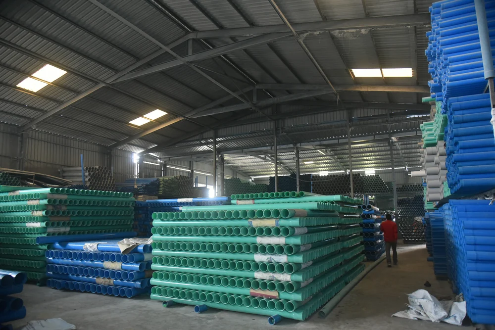 SHIVA PVC pipe inventory — green, blue, white pipes in warehouse